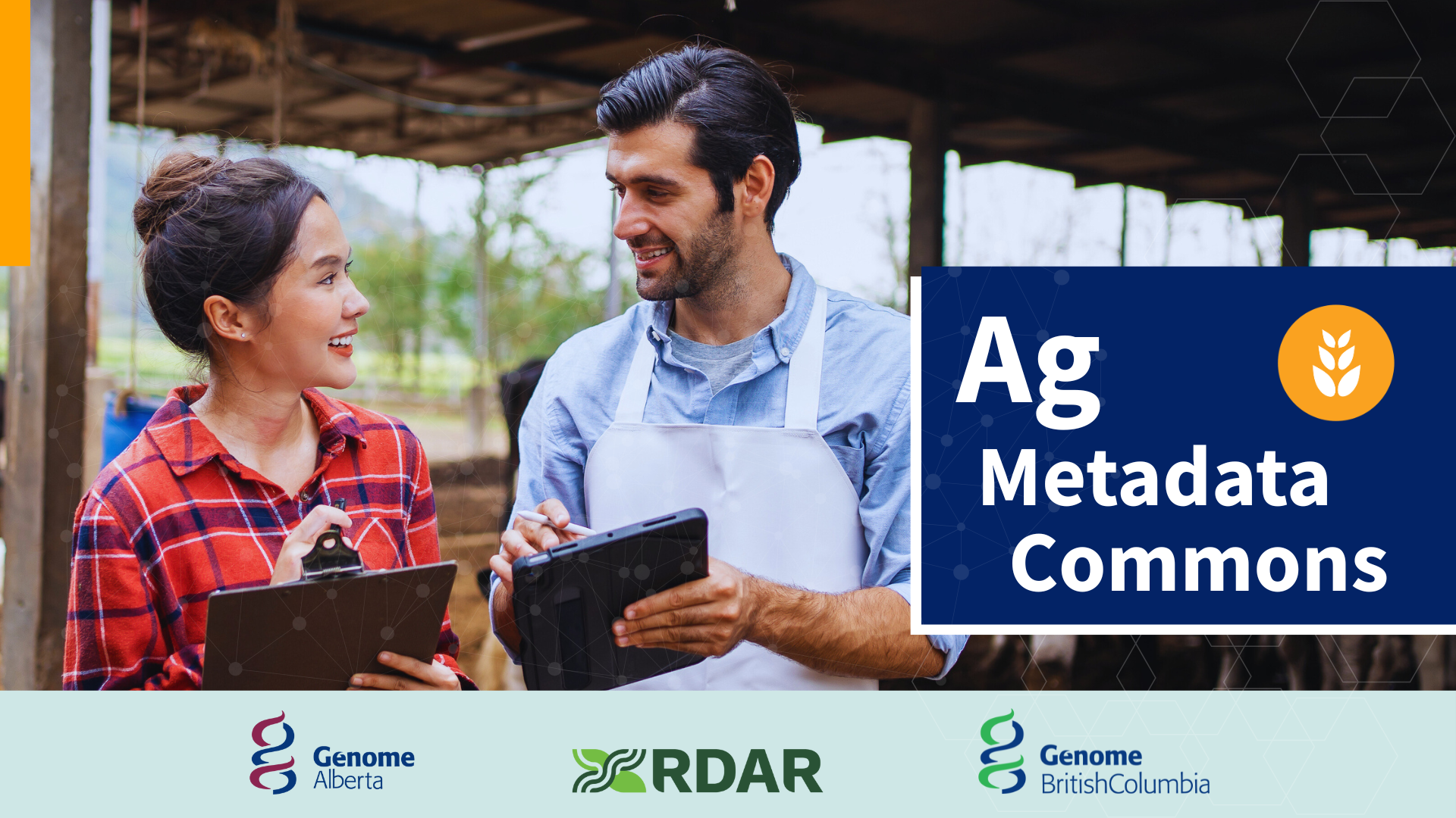 Two farmers holding tablets standing in front of a barn.